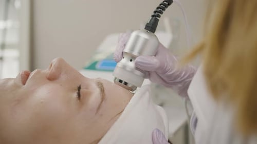 Cosmetology session featuring permanent makeup application on a girl in a beauty studio