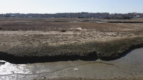 Aerial Low flight over Marsh in Winter at Scituate MA. Steady drone forward motion.