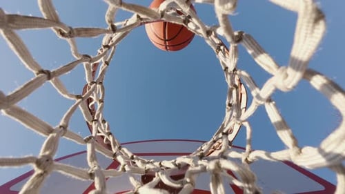 Basketball Shot Flying Into Hoop Outdoors Scoring A Goal On Court