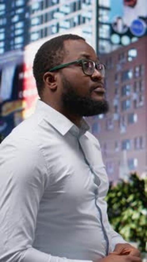 Vertical Video Black Adult Male with Trendy Style and Dynamic Attitude Walks a Downtown Street