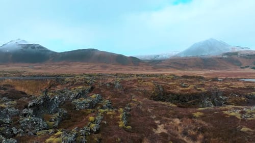 Lava field in a mountain valley in Iceland - drone low altitude pullback reveal