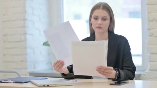 Businesswoman Working on Documents in Office, Paperwork