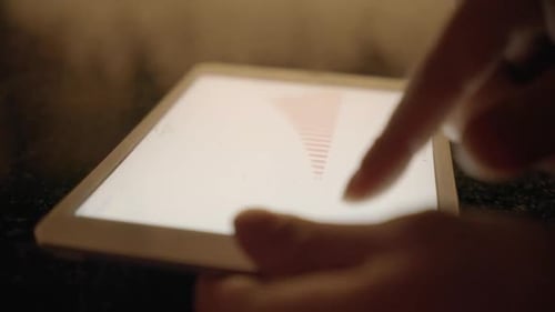 Hand Interacts With Data Charts on Tablet