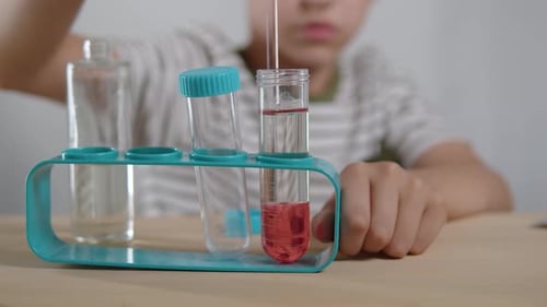 Child Doing Science Experiment at Home with Test Tubes