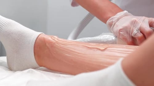 Woman Cosmetologist Doing Legs Laser Hair Removal Procedure Female Client