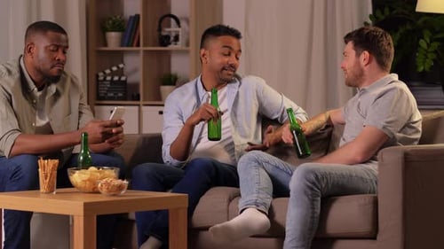 Friends Relaxing on Couch with Drinks and Snacks