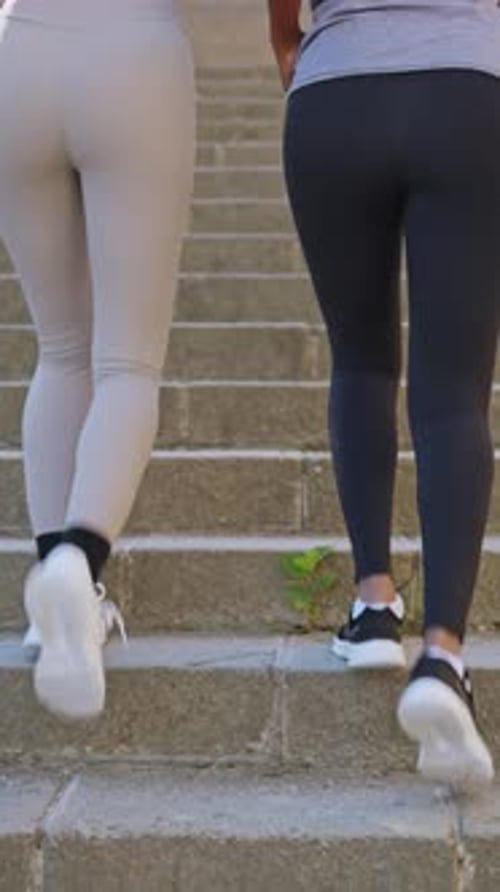 Women Ascending Steps in Sportswear