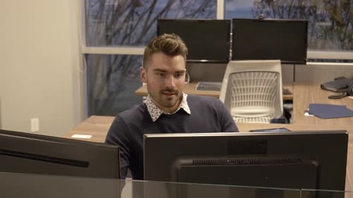 Young businessman concentrating on computer in modern office work station
