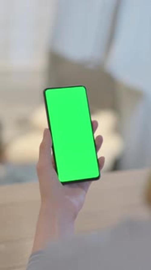 Close Up of Young Woman Using Phone with Green Screen, vertical video