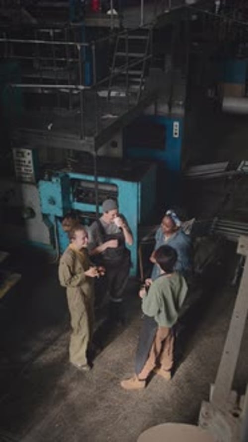 Female Co-workers Talking during Coffee Break at Factory
