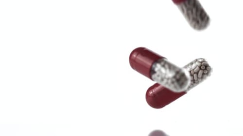 Pills Capsules Falling in Slow Motion