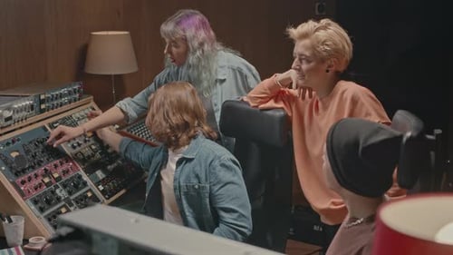 Young Music Band Coworking at Record Studio