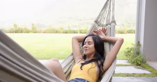 Woman Relaxing in Hammock on Sunny Day