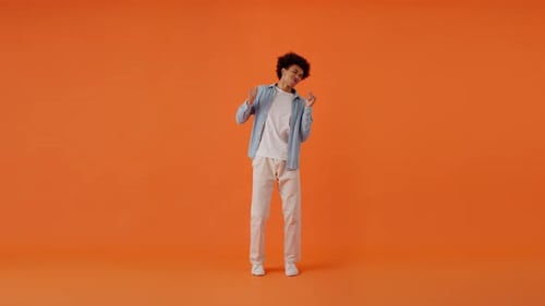 Cheerful Male Dancing Actively While Standing in Studio