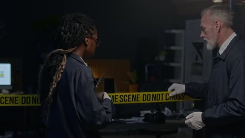 Detectives Discussing Crime Scene Investigation in Office