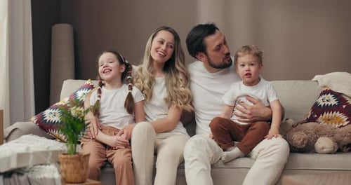 Happy Family Relaxing Together on the Couch at Home