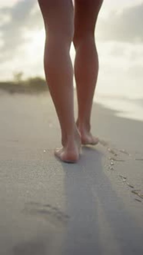 Female Legs on Sand of Beautiful Oceanic Shore Back View Woman Walking Alone on Coastline in Summer