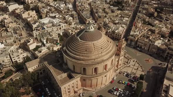 Aerial view of the Rotunda church in Mosta, Malta. Long rotating shot ...