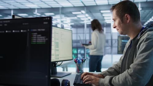 System Administrator in Server Room Doing System Analysis Coding