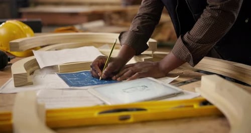 Carpenter, hands and blueprint with pencil for construction, furniture or project