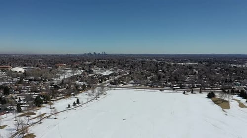 A drone shot over a park outside of Denver after a spring snowstorm