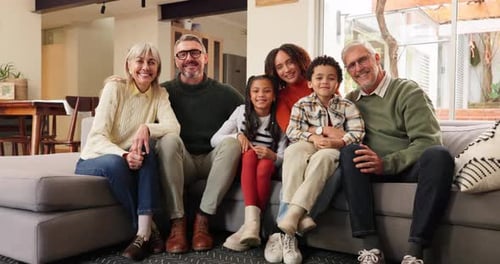 Family Group Portrait Smiling on Sofa Indoors