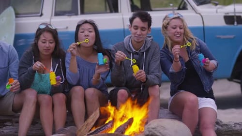 Group of Friends at Beach Blowing Bubbles by Campfire Beach