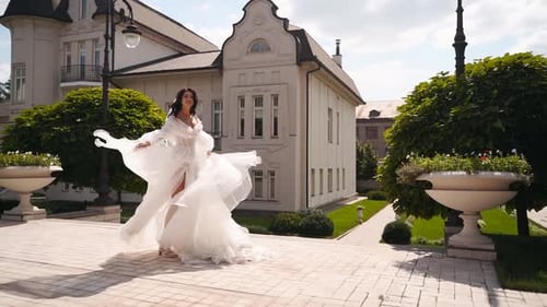Beautiful Woman in White Dress Twirling