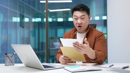 Excited Man Reading Good News in Office