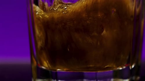 Pouring Cola with Bubbles Into the Glass Close Up Stock Clip Coke Soda in Transparent Glass on a