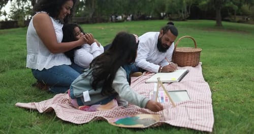 Indian Parents Having Fun at City Park Painting with Their Children -