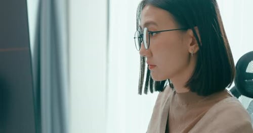 Closeup young adult Asia female freelance eyeglasses typing write prompt AI bot IT app.