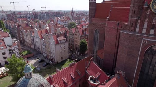 Drone Flight Around the Ancient Cathedral in the Center of the Old European Town with Tile Roofs