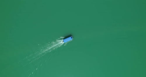 A Motor Boat with a Canopy Floats on a Lake