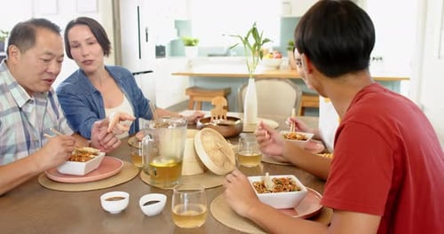 Family and Friends Enjoy Meal Together at Home
