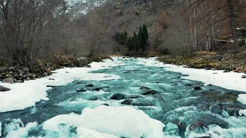 Breathtaking Cold River Flowing Through Snow Covered Winter Mountain Forest