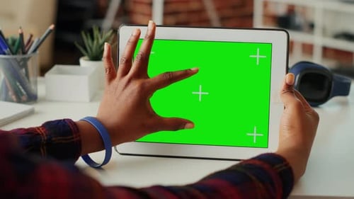 Office Employee Using Horizontal Greenscreen on Wireless Device