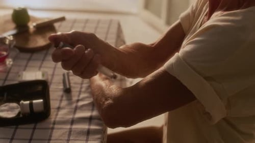 Senior Person Administering Medication with Pen Injection