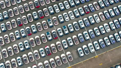 Aerial view from drones flying over a lot of cars