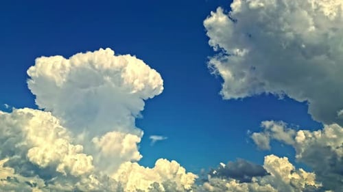 Majestic White Clouds Drifting Across Blue Sky