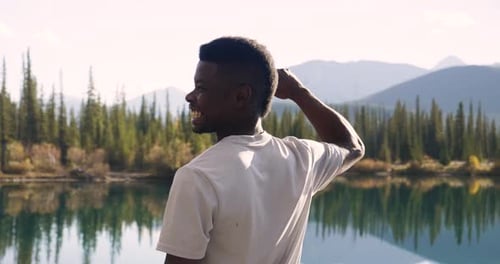 Man Looking At Sunny Scenic Mountain Lake View