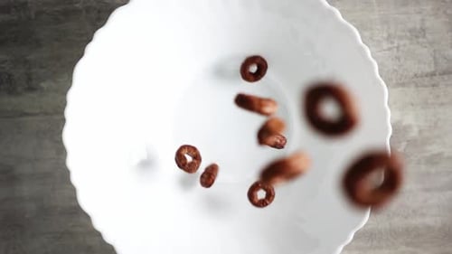 Chocolate Cereal Rings Falling Into Bowl