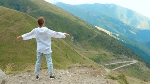 Woman Raising Arms Enjoying Mountain View