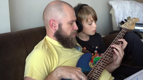 Father and Son Play Electric Bass Guitar Together