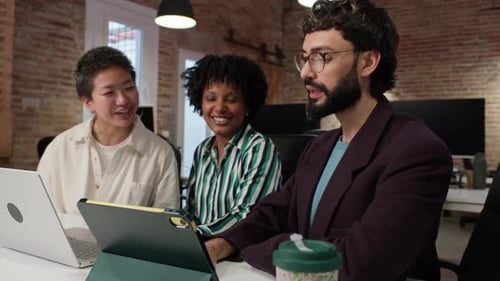 Team Collaborating on Tablet in Modern Office