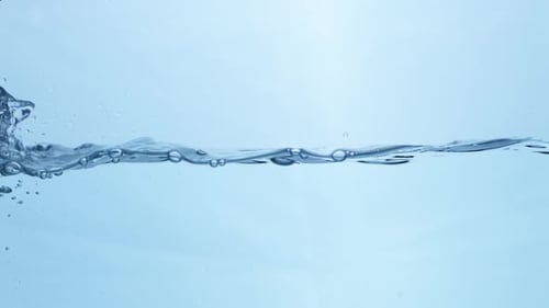 Abstract Water Flow in Motion. Clear Liquid Creating Natural Ripples on a Smooth Surface.