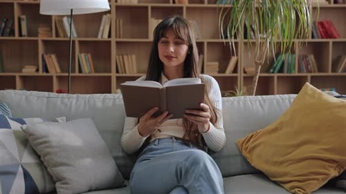 Woman Relaxing at Home Reading a Book