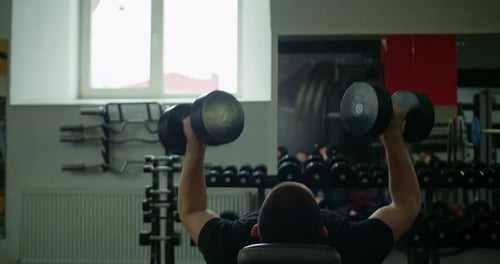 Man Lifting Weights at the Gym