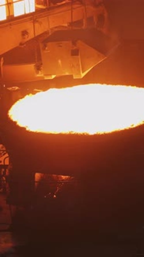 Witness the Intense and Mesmerizing Molten Metal Pouring Process Occurring in a Foundry Setting