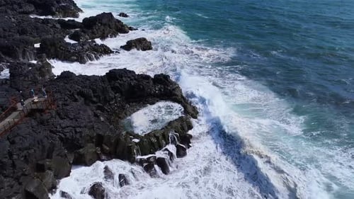 Aerial view of rocky coastline and waves, Iceland.